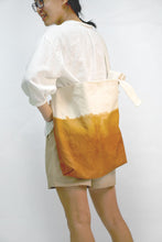 Load image into Gallery viewer, Model carry Eco friendly canvas bag with adjustable strap by Xiapism Natural Dye Sustainable Fashion