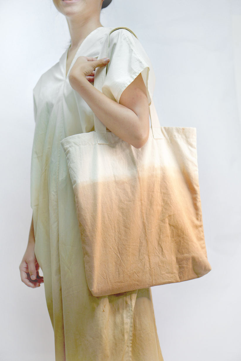 A minimalist designer tote bag with a few inner pockets for ease of use. Design and Crafted by Xiapism Natural Dye Sustainable Lifestlye