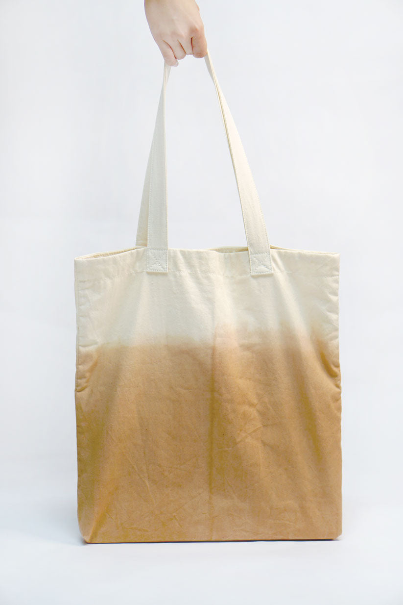 A minimalist designer tote bag with a few inner pockets for ease of use. Design and Crafted by Xiapism Natural Dye Sustainable Lifestlye
